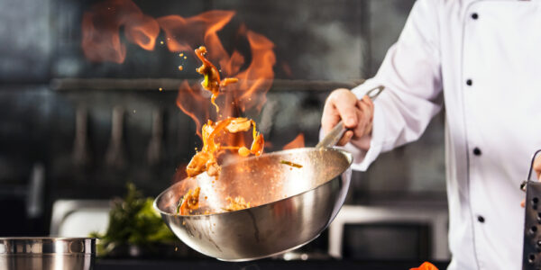 Chef,Hands,Keep,Wok,With,Fire.,Closeup,Chef,Hands,Cook